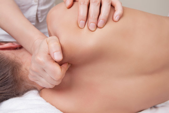 Professional  therapist doing neck and shoulder deep tissue and sport massage