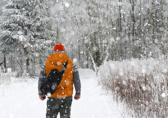 Man Winter in the forest with backpack - 127185542