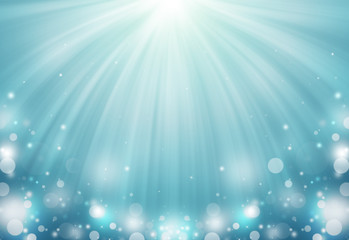 Cyan color glitter sparkles defocused rays lights bokeh abstract background/texture.