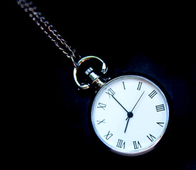 old pocket watch on black background