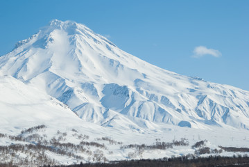 Volcano Viluchinsky covered with snow at sunny winter day