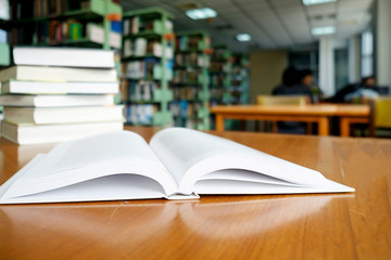Reading concept. Vintage tone of open book on the desk in library.
