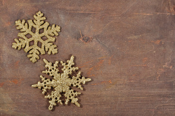 Two snowflakes on a wooden background