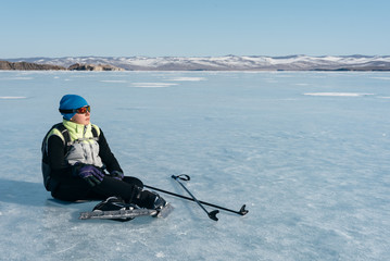 Tourists travel to Norway hiking ice skating on the frozen lake. Special long skate for long distances. Mounting under the ski boots. Location of Lake Baikal action. The Russian called Bayes or Loft.