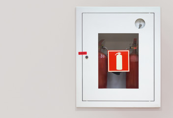 Two wall mounted fire extinguishers in an easily accessible box
