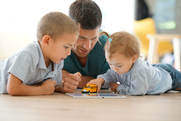 Daddy playing with kids at home