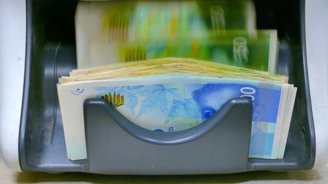 Israeli Shekel banknotes counted by a Currency counting machine 