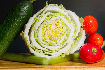 composition red bell pepper, celery, and tomatoes and cucumber on a cutting Board. ingredients for vegetable salad
