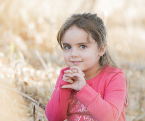 Little Girl with Long Hair Playing Outside in a Natural Environment