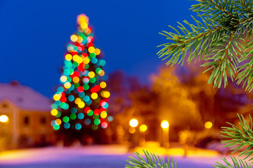 Christmas background with unfocused Christmas tree by night