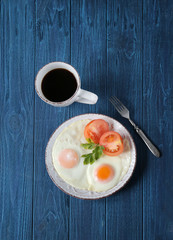 breakfast with fried eggs,tomato and coffee