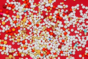 Top view colorful medicine on red background.