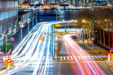 Light trails on the busy night streets, crossroad in big city