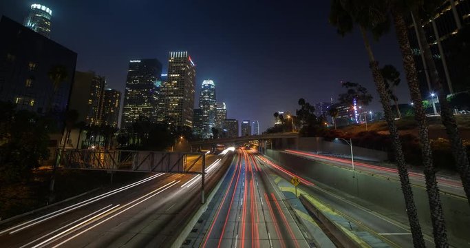 Los Angeles, California, USA - Light trails of passing cars at Freeway 110 - view from Bridge 3rd St. at Financial District facing southwest at night - Timelapse with zoom in 