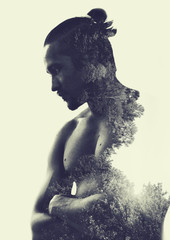 Double exposure :  muscular young man and  forest