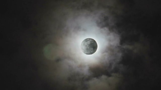 The full moon lay hidden behind the clouds in the middle of the lunar month (or Loi krathong day of Thailand). (HD footage no sound)