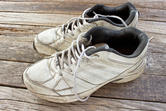 Old sneakers on wooden background