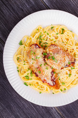 Chicken parmesan and pasta. Chicken breasts and spaghetti. View from above, top studio shot
