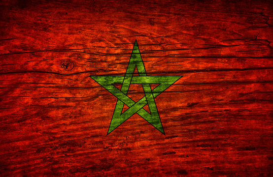 The national vintage flag of Morocco on wooden surface