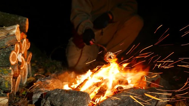 4K .Man Roasting Marshmallows At Camp Fire