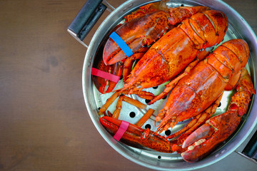 Overhead view of Maine Lobster in the iron steamer on a dark wooden table