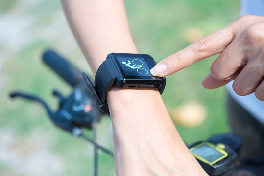 Close-up smart watch on arm women to ride a bicycle