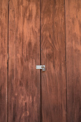 Vintage brown wooden locked door with old door knob