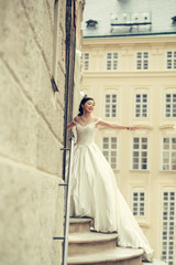 Pretty bride stands on steps