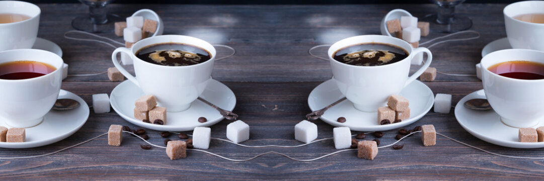 Tea, black tea, green tea, black espresso coffee in white porcelain cups on rustic wooden table. Wide panoramic image. 