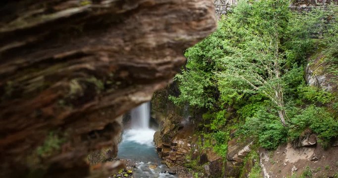 Mount Rainier National Park, Washington, USA - Christine Falls with famous stonebridge at forest - Timelapse with motion and zoom in