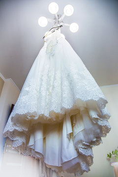beautiful wedding dress hung on the chandelier