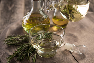 Assortment of spicy sunflower,corn,sesame seeds ,avocado ,grape seeds oils with herbs and spices in different bottles on wooden background