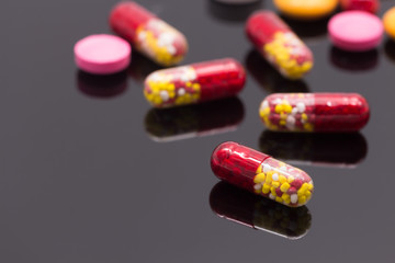 Colorful pills over dark background