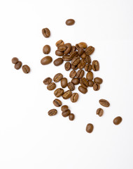 Coffee beans on a white surface.