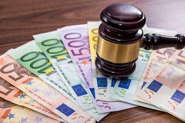 Law gavel with euro on wooden desk