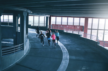 Runners inside parking building