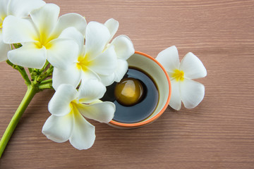 Fototapeta na wymiar Raw Egg in soy sauce and Plumeria flower,Tamago kake gohan