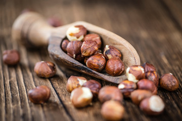 Hazelnuts on vintage wooden background (selective focus)