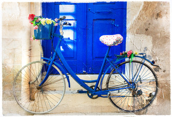 Fototapeta na wymiar charming floral street decoration with old bike. Retro picture