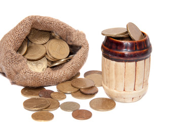 Bag with coins barrel with coins on a white background.