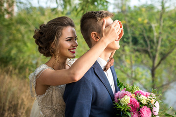 Guess who? The bride and groom in the park, wedding photo shoot. The smiles and cheerful mood