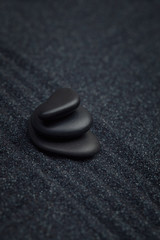 Black pebbles on a raked sand