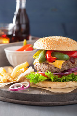 homemade cheese burger with peppers tomato onion