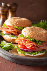 ham sandwich on bagel with cream cheese tomato onion