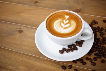 Coffee cup with on wooden table. View from the top