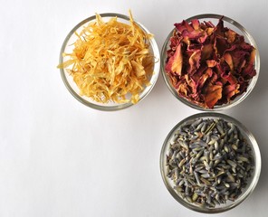 Dried petals of marigold with rose and lavender for spa treatments - top view with copy space