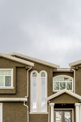 The top of the house or apartment building with nice window.