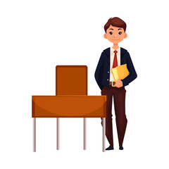 Clever school boy standing at the desk and holding a book, cartoon vector illustration isolated on white background. Full height portrait of pretty boy in school uniform standing at the desk