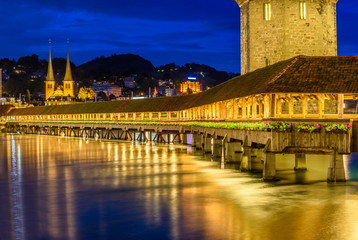 Night view towards Chapel Bridge (Kapellbruecke) together with the octagonal tall tower...
