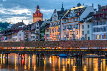 Night view towards Chapel Bridge (Kapellbruecke) together with the octagonal tall tower (Wasserturm) it is one of the Lucerne's most famous tourists attraction